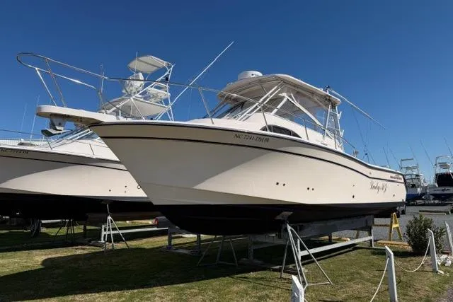 Slide: The Image of 2007 Grady-White Marlin 300 boat on display under clear blue sky. - 3