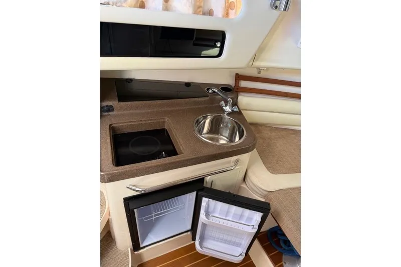 Slide: The Image of 2007 Grady-White Marlin 300 boat interior with kitchenette, sink, and mini fridge. - 32