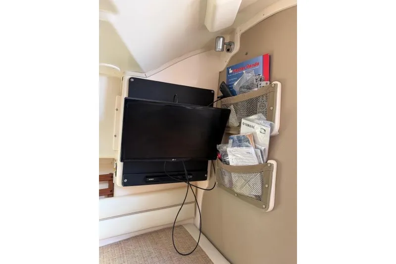 Slide: The Image of Interior of 2007 Grady-White Marlin 300 with TV and storage pockets. - 34