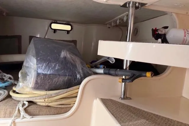 Slide: The Image of Interior of 2007 Grady-White Marlin 300 boat with stored equipment and fire extinguisher. - 35