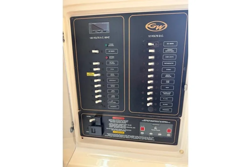 Slide: The Image of Electrical panel of a 2007 Grady-White Marlin 300 boat, featuring AC and DC switches. - 36