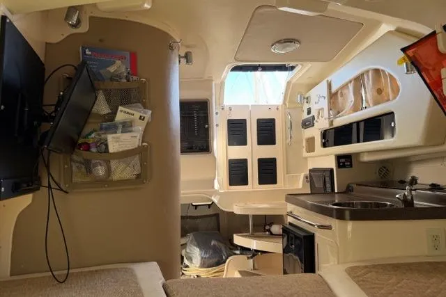 Slide: The Image of Interior of 2007 Grady-White Marlin 300 boat with kitchenette and seating area. - 37