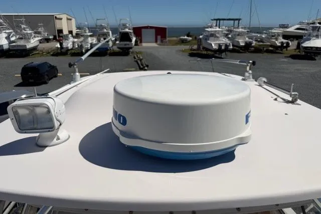 Slide: The Image of 2007 Grady-White Marlin 300 boat radar and spotlight on deck, marina background. - 43