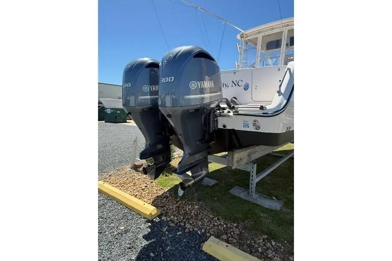 Slide: The Image of 2007 Grady-White Marlin 300 with twin Yamaha 300 engines, parked on gravel. - 7