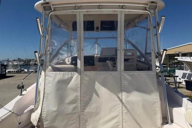 Slide: The Image of 2007 Grady-White Marlin 300 boat with enclosed cockpit, docked at marina. - 9