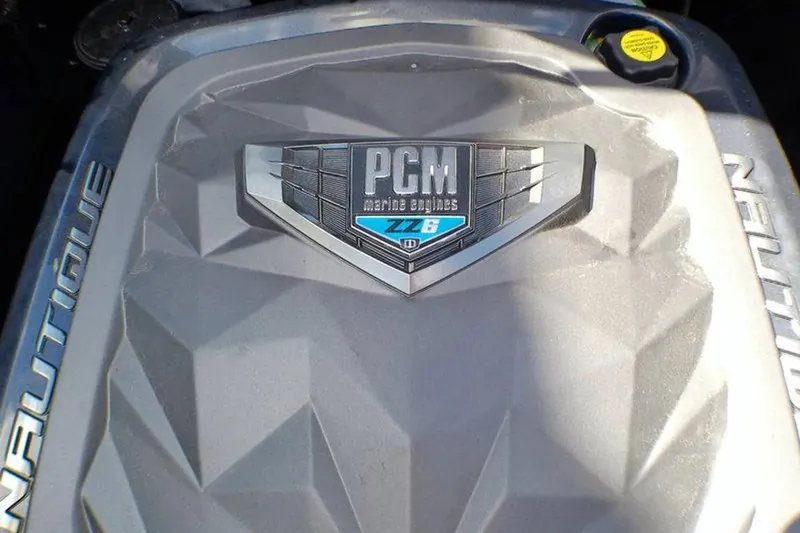 Slide: The Image of Engine cover of 2021 Nautique Super Air Nautique G23 Coastal Edition with PCM branding. - 10