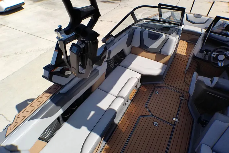Slide: The Image of 2021 Nautique Super Air Nautique G23 Coastal Edition interior with sleek seating and teak flooring. - 12