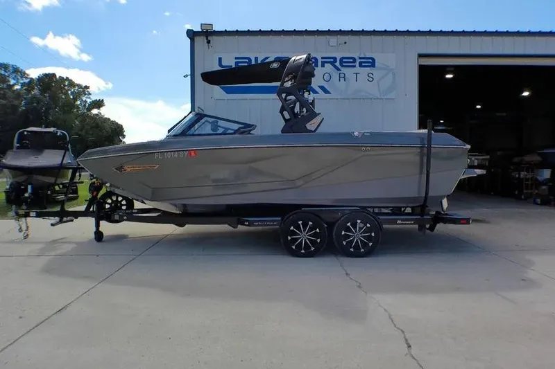 Slide: The Image of 2021 Nautique Super Air Nautique G23 Coastal Edition boat on trailer outside dealership. - 2
