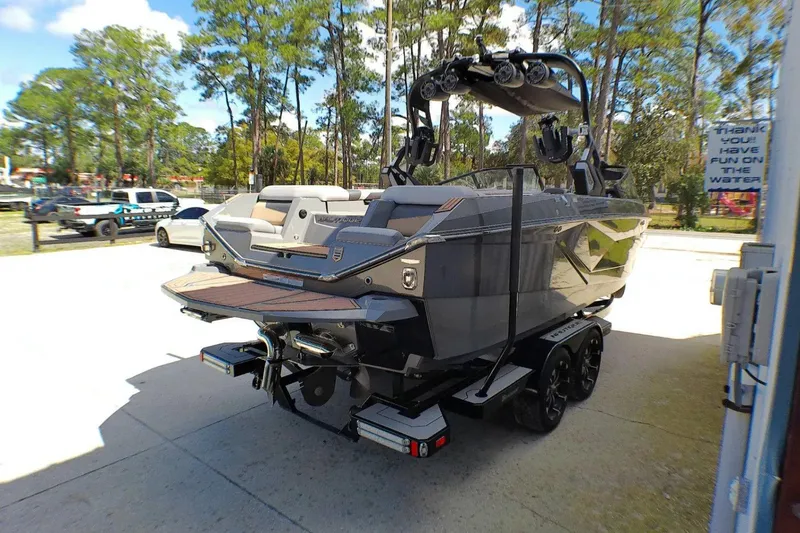 Slide: The Image of 2021 Nautique Super Air Nautique G23 Coastal Edition boat on trailer, parked outdoors. - 5