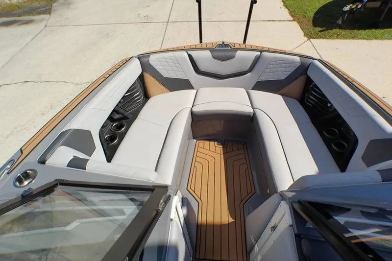 Slide: The Image of Interior view of 2021 Nautique Super Air Nautique G23 Coastal Edition boat, featuring luxurious seating. - 6