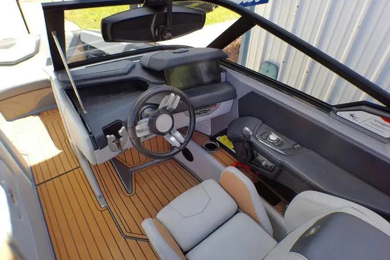 Slide: The Image of Interior of 2021 Nautique Super Air Nautique G23 Coastal Edition boat, featuring sleek design and controls. - 8