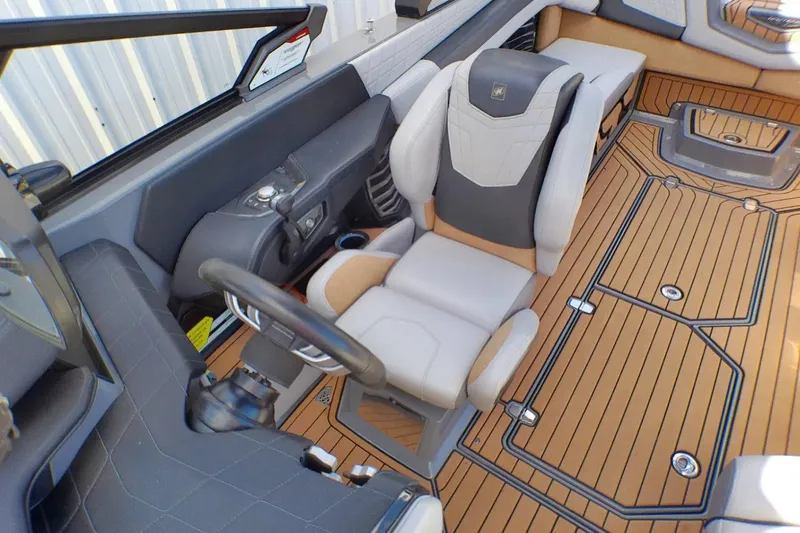 Slide: The Image of 2021 Nautique Super Air Nautique G23 Coastal Edition interior with luxury seating and modern dashboard. - 9