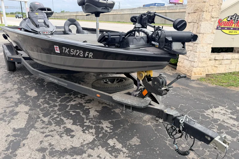 Slide: The Image of 2020 Vexus AVX1880 boat on trailer, featuring Minn Kota motor, parked at South Austin Marine. - 3
