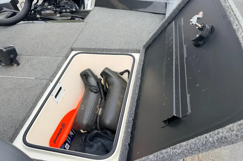 Slide: The Image of Open storage compartment in a 2020 Vexus AVX1880 boat, containing boating accessories. - 34