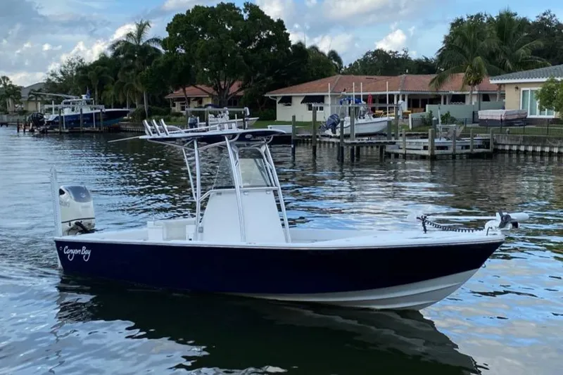 The Image of 2014 Canyon Bay 24H boat on calm water near dock. - 0