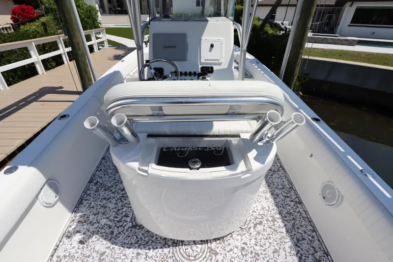Slide: The Image of 2014 Canyon Bay 2400 boat interior with rod holders and Garmin equipment. - 12