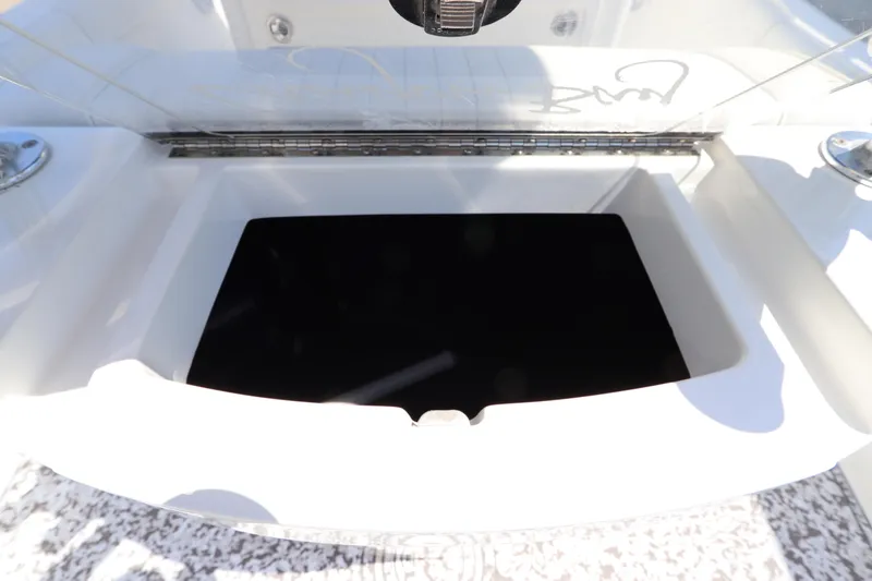 Slide: The Image of Open storage compartment on a 2014 Canyon Bay 2400 boat, showcasing interior space. - 13