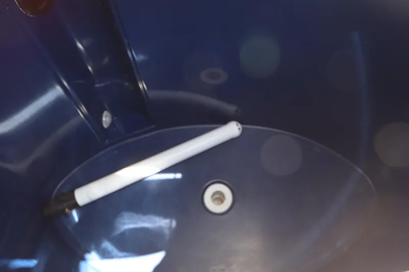 Slide: The Image of Interior of a 2014 Canyon Bay 2400 boat, featuring a blue compartment with a white rod. - 14