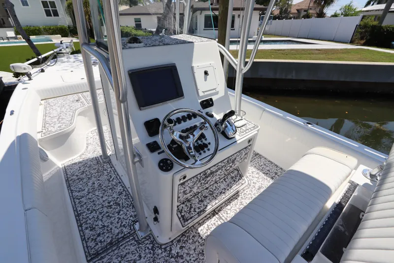 Slide: The Image of 2014 Canyon Bay 2400 boat interior with modern console and seating. - 15