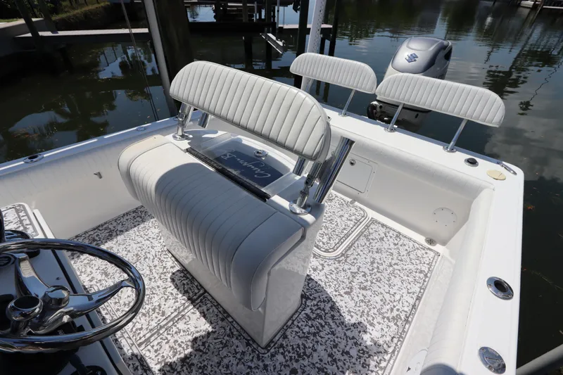 Slide: The Image of 2014 Canyon Bay 2400 boat interior with white seating and steering wheel. - 16