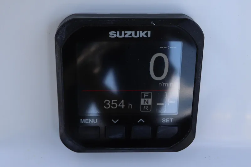 Slide: The Image of Suzuki digital display showing 0 RPM and 354 hours on a 2014 Canyon Bay 2400. - 21