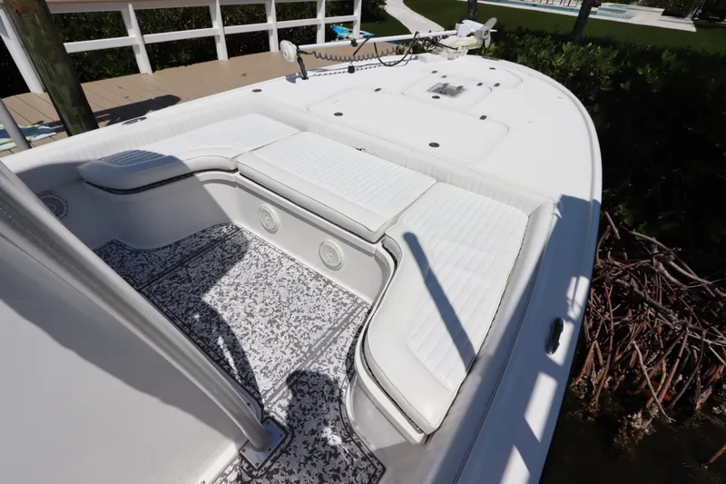 Slide: The Image of 2014 Canyon Bay 2400 boat with white seating and patterned flooring. - 24