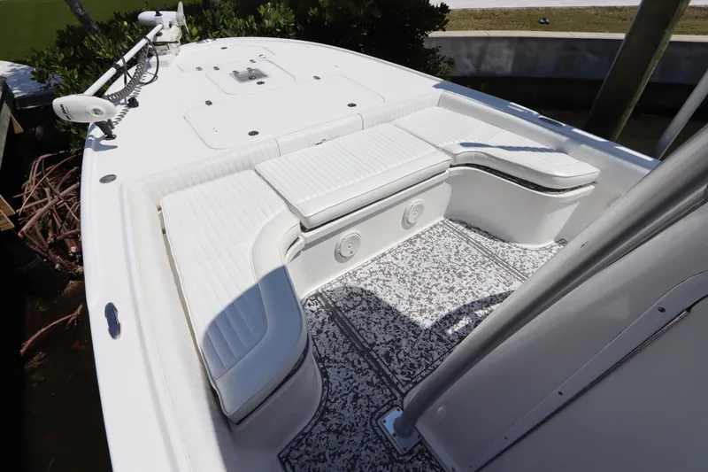 Slide: The Image of 2014 Canyon Bay 2400 boat interior with white seating and patterned flooring. - 25