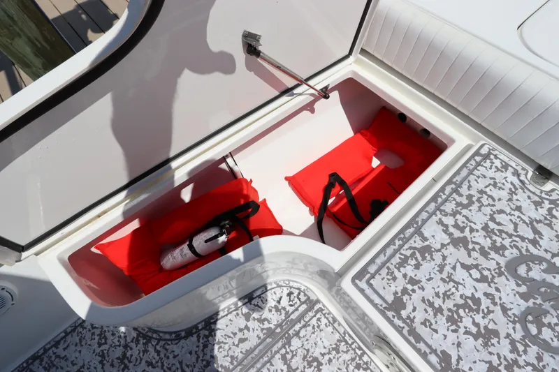 Slide: The Image of 2014 Canyon Bay 2400 boat storage with life jackets and fire extinguisher. - 27