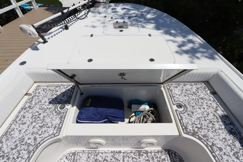 Slide: The Image of Open storage compartment on 2014 Canyon Bay 2400 boat, containing rope and equipment. - 28