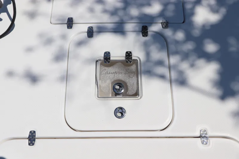 Slide: The Image of Hatch on 2014 Canyon Bay 2400 boat, featuring secure latches and shadow patterns. - 31
