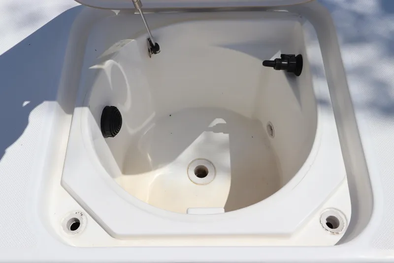 Slide: The Image of Livewell compartment of a 2014 Canyon Bay 2400 boat, featuring drainage and aeration systems. - 32