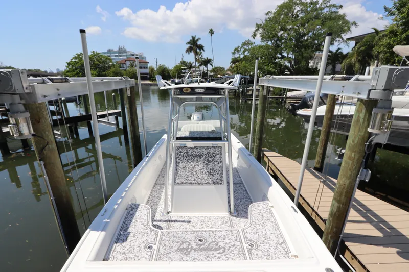 Slide: The Image of 2014 Canyon Bay 2400 boat docked in a scenic marina setting. - 34