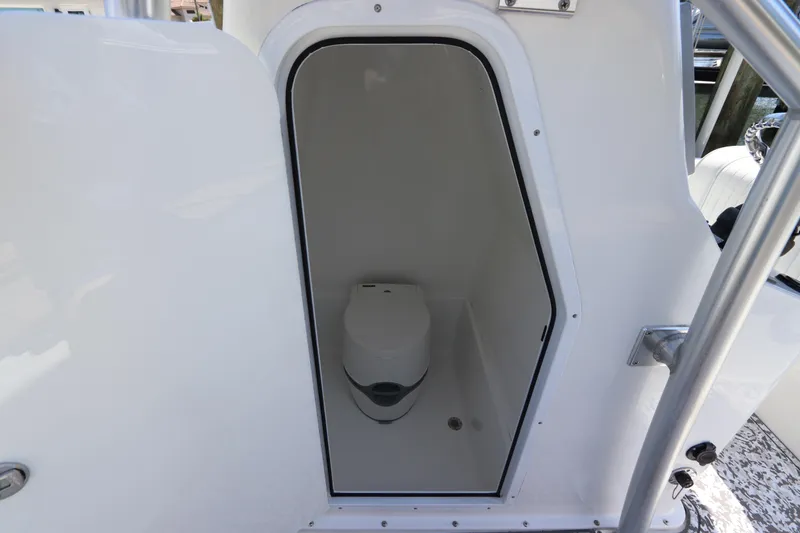 Slide: The Image of Compact marine toilet inside a 2014 Canyon Bay 2400 boat cabin. - 35