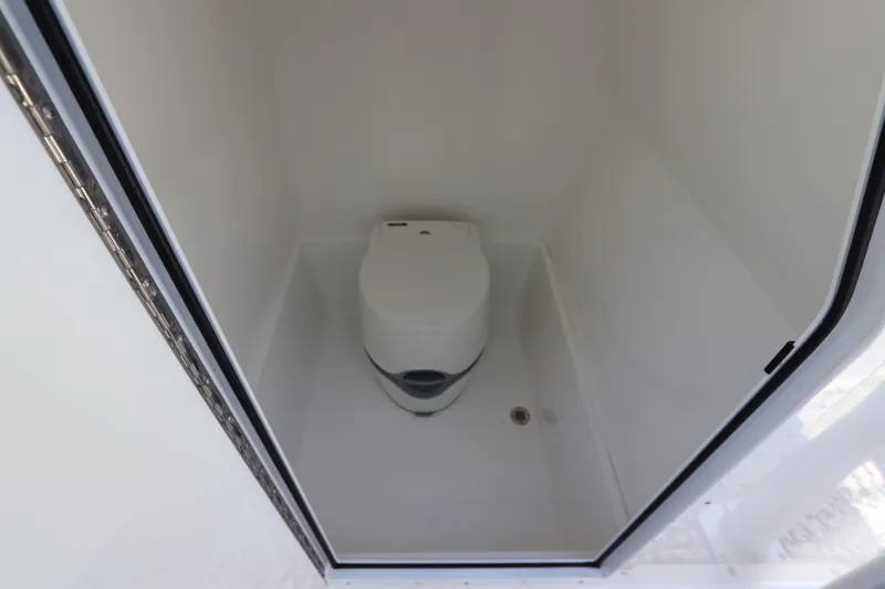 Slide: The Image of Compact marine toilet in 2014 Canyon Bay 2400 boat interior. - 36