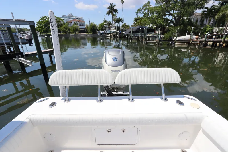 Slide: The Image of 2014 Canyon Bay 2400 boat with Suzuki 350 engine docked in a serene marina. - 6