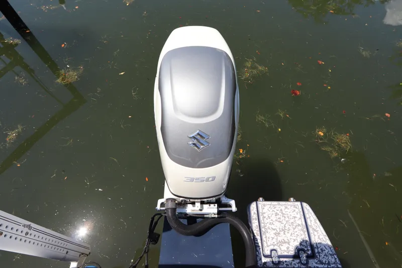 Slide: The Image of Outboard motor on a 2014 Canyon Bay 2400 boat, floating in calm water. - 9