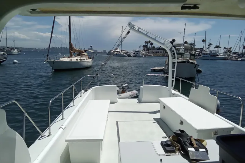 Slide: The Image of 1972 Uniflight 40 boat docked in a marina with sailboats and clear skies. - 3