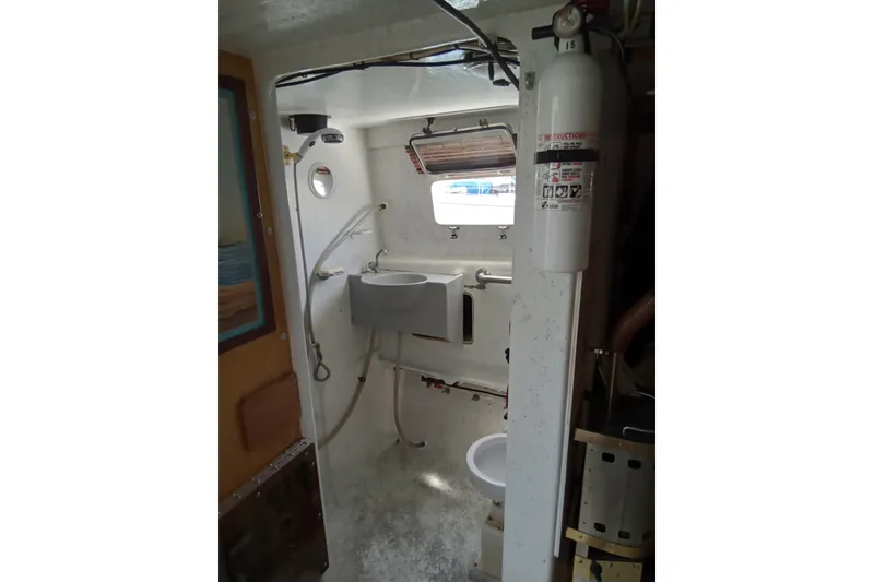 Slide: The Image of 1972 Uniflight 40 boat interior with sink, toilet, and fire extinguisher. - 4
