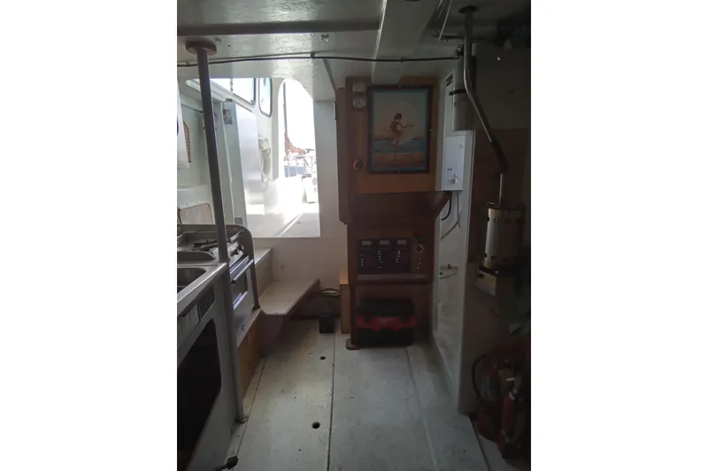 Slide: The Image of Interior of a 1972 Uniflight 40 boat, featuring a compact kitchen and control panel. - 6