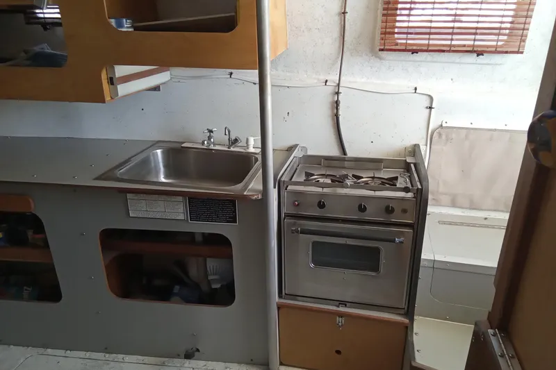 Slide: The Image of 1972 Uniflight 40 boat kitchen with stove, sink, and wooden cabinets. - 7