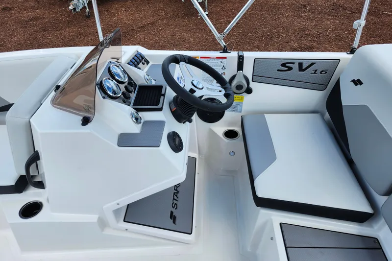 Slide: The Image of 2026 Starcraft SV 16 OB boat interior with steering wheel and dashboard controls. - 15