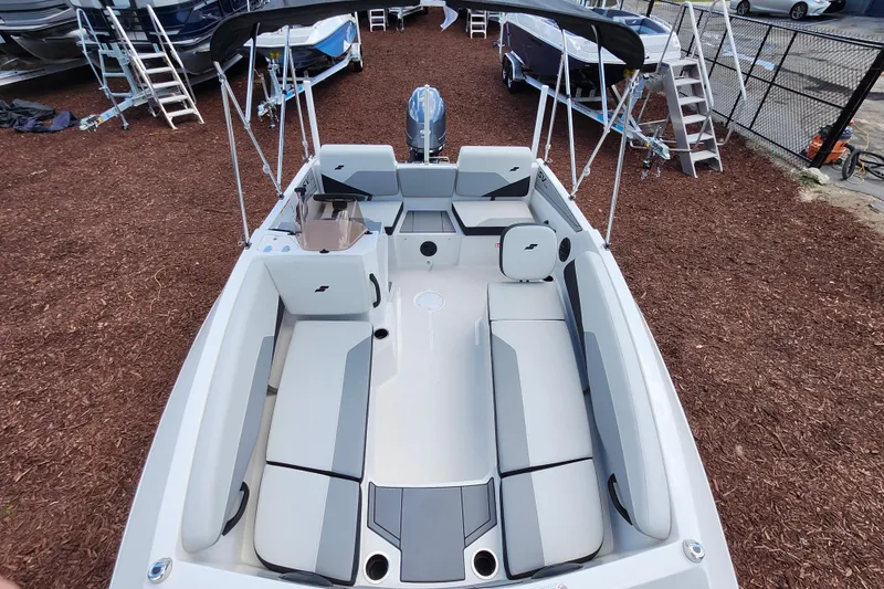 Slide: The Image of 2026 Starcraft SV 16 OB boat with spacious seating and modern design in a showroom. - 18