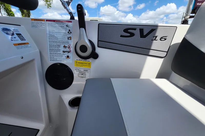 Slide: The Image of Interior view of 2026 Starcraft SV 16 OB boat, featuring seating and control panel. - 24
