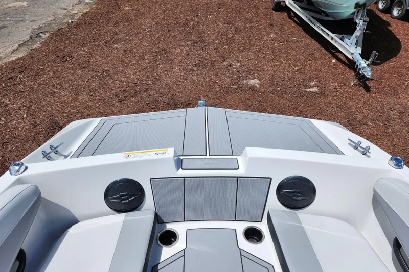 Slide: The Image of 2026 Starcraft SV 16 OB boat interior with seating and speakers, parked on mulch ground. - 30