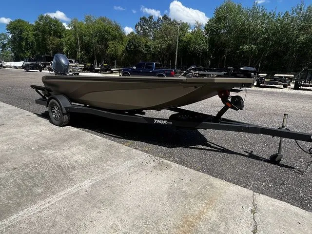 Slide: The Image of Thor 1754 Fish Hammer 2026 on trailer, green, parked outdoors. - 6