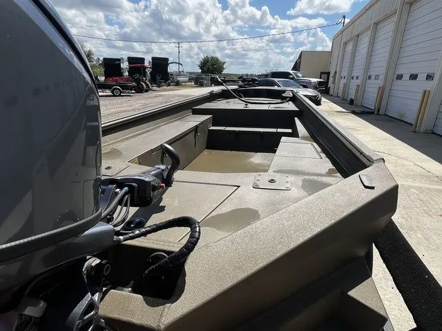 Slide: The Image of 2026 Thor 1754 Fish Hammer boat in green, parked outdoors. - 9