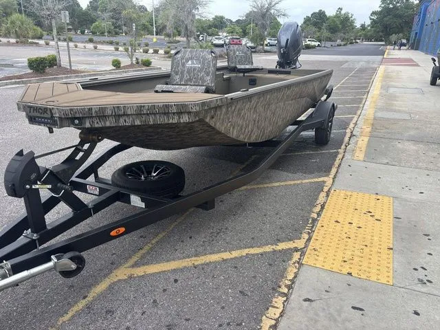 Slide: The Image of 2026 Thor Boats 1860 Lake Hammer Elite parked on trailer. - 10