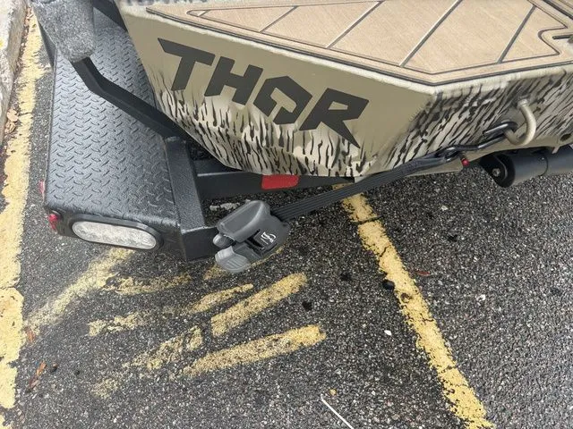 Slide: The Image of Thor Boats 1860 Lake Hammer Elite 2026 on trailer, close-up view. - 18