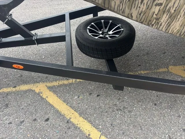Slide: The Image of Thor Boats 1860 Lake Hammer Elite 2026 on trailer with spare tire. - 19