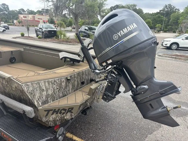 Slide: The Image of Thor Boats 1860 Lake Hammer Elite 2026 with Yamaha engine parked outdoors. - 4